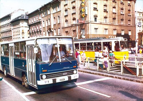 A 12-es busz egykor a 6-os és a 61-es villamos által alkotott teljes kört járta végig mindkét irányban. A képen az Üllői úti kereszteződésnél várakozik a Corvin mozi előtt. A villamosokra és a buszokra ekkor még külön viteldíj volt érvényes, ezért is közlekedett sok párhuzamos járat