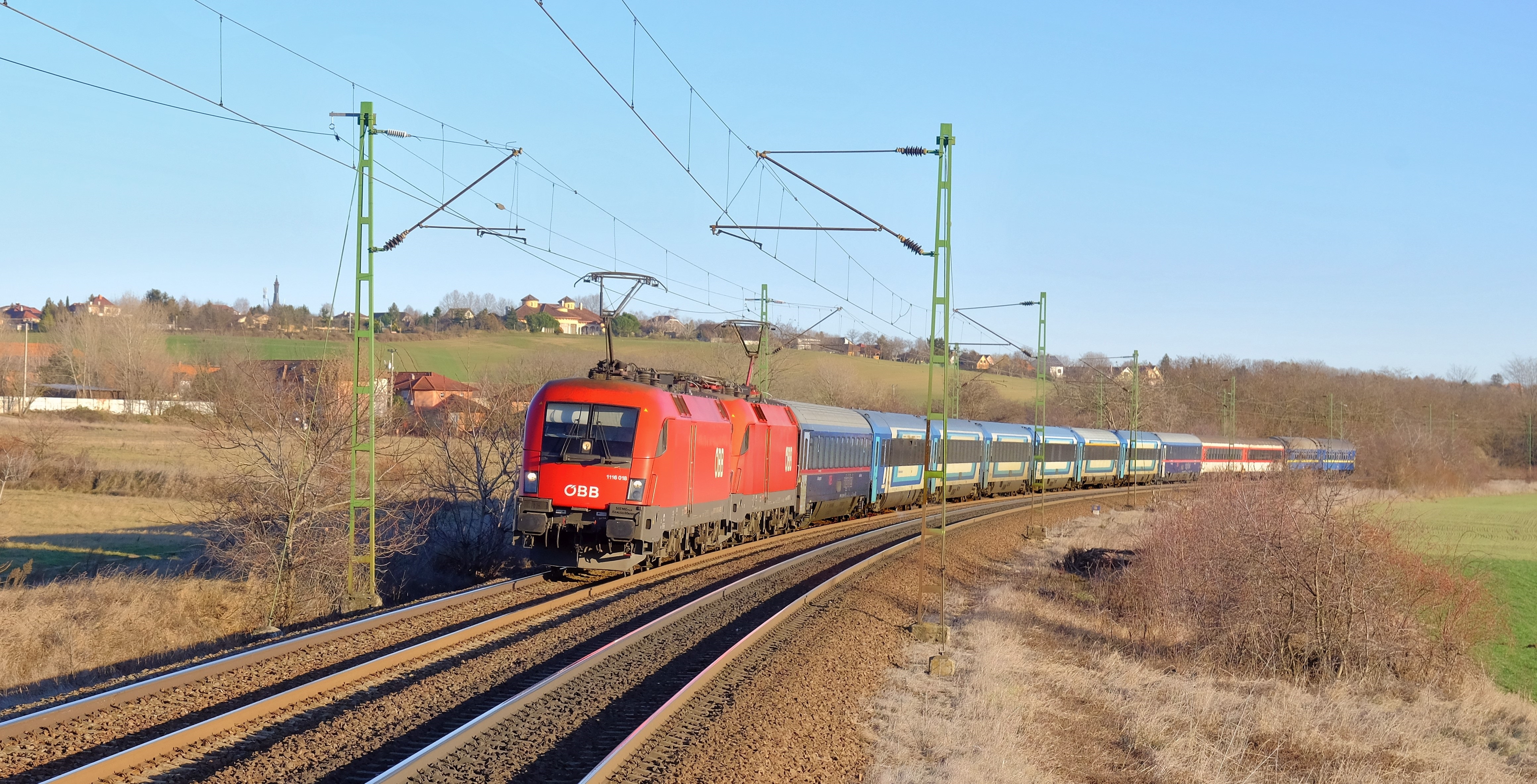 Tavaly december 30-án a 146-os Tisza–Szamos eurocity-vonat robog Rákoskertnél két Taurus mozdonnyal és 12 kocsival – a szerelvény összetétele meglehetősen vegyesre sikeredett. Tudni kell, hogy a vonatban a menetrendváltás óta már nincsenek román kocsik, helyettük az ÖBB adott ki – itt éppen – két nightjet kocsit. A vonat végén még két-két szlovák és ukrán kocsi látható (fotó: Balázs Zsolt)