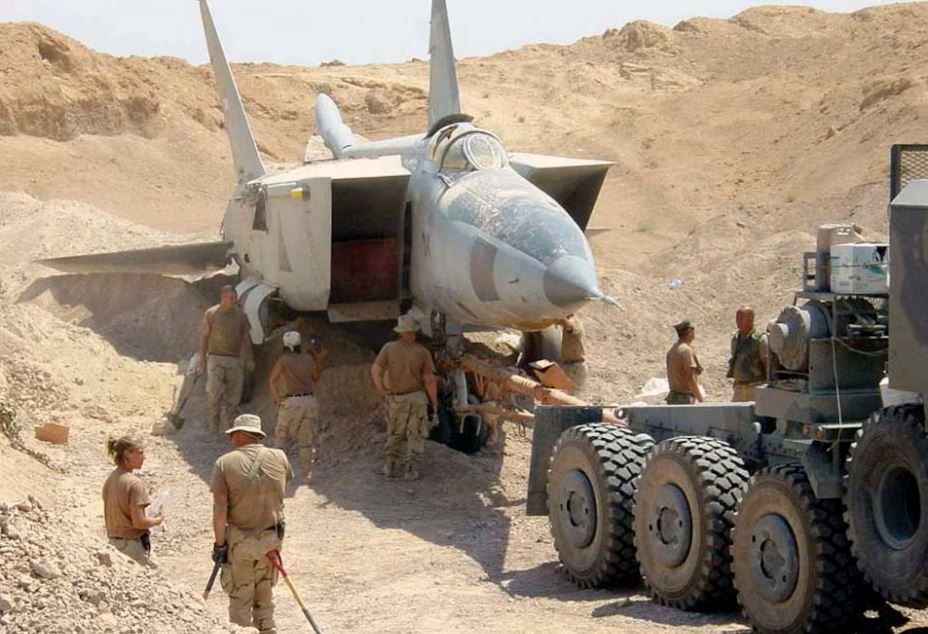 Amerikai erők nehézvontatóval cibálnak ki egy MiG-25R Foxbat-B vadászgépet a homok alól Irakban, 2003. július 6-án (fotó: T. Collins)